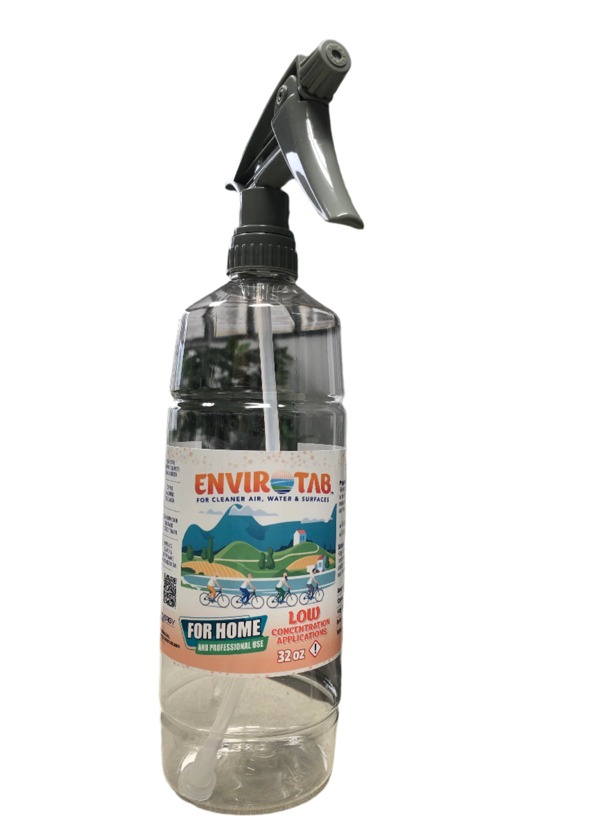 Clear spray bottle with a label on a surface, with a blurred indoor background